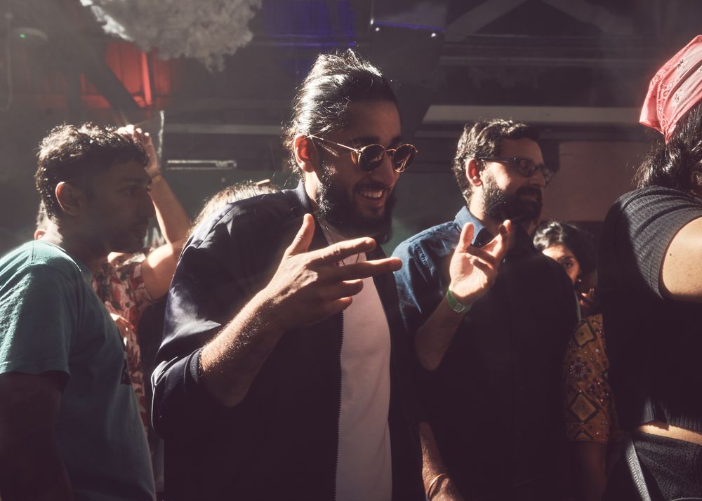 London, England, United Kingdom - Nov 9, 2022: Man wearing sunglasses inside enjoying dance