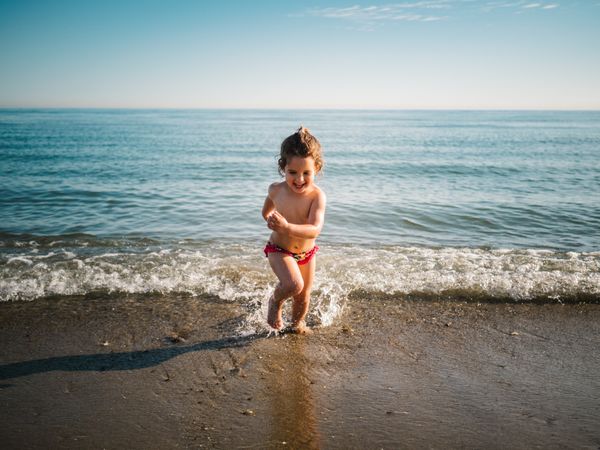 Cheerful girl after bathing in warm sea