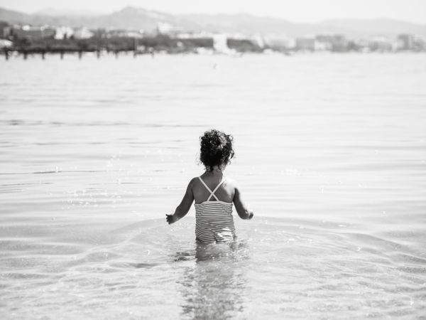 Cheerful girl having fun in warm sea