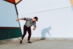 Trendy male flipping on street