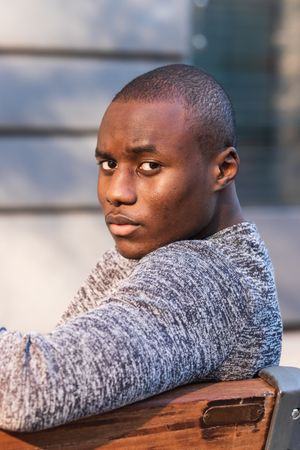 Black man resting on urban bench