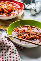 Traditional Ukrainian beetroot borscht soup in green bowl