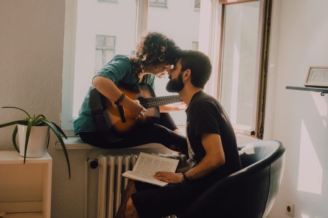 Cheerful couple spending time together at home