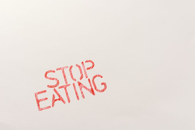 Simple red inscription calling to stop eating