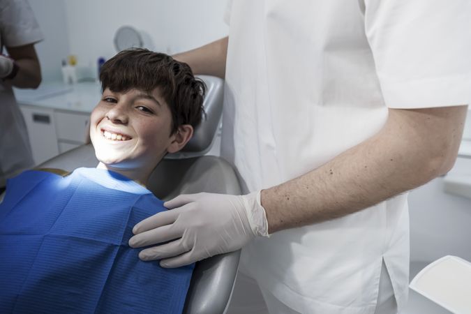 Portrait of teenager boy smiling at the dentist