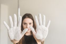 Young woman showing hands in chalk