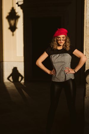 Stylish female standing near building wall