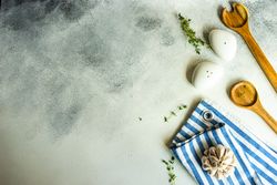 Top view of salt and pepper shakers, thyme and garlic on concrete background with copy space