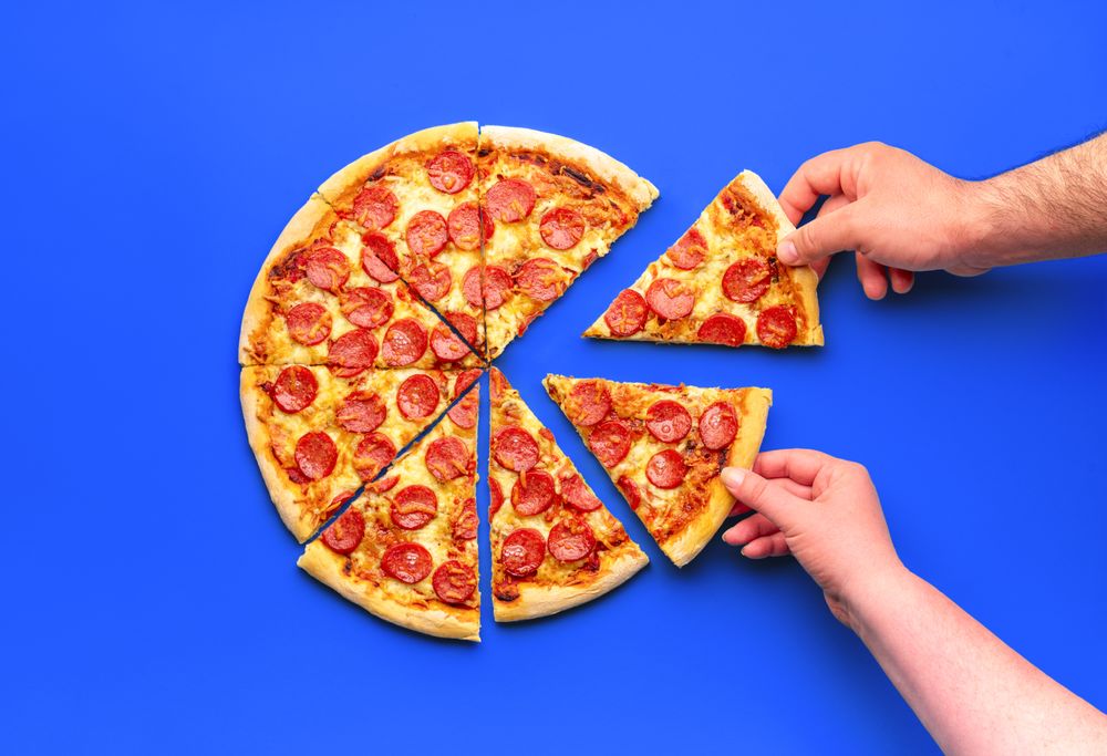 Homemade pizza with pepperoni, minimalist on a blue table