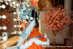 Side view of Chinese actress in her cultural outfit sitting beside mirror 4NJol4