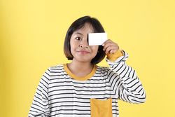 Asian Kids Holding Empty Bank Card for Close One of Her Eye