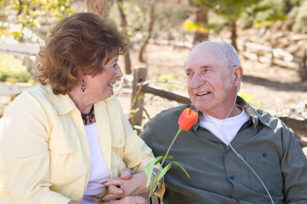 Mature Woman with Man Wearing Oxygen Tubes