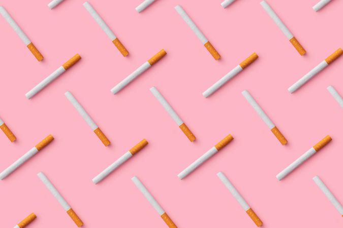 Cigarettes on pink background