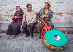 Tibet - August, 29 2014: people sitting on street bench