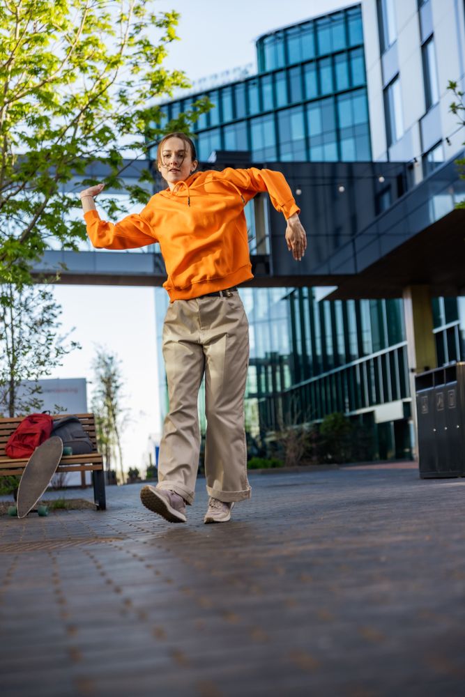 Vertical Screen: Young Female Hip Hop Dancer Freestyling On City Street Among Tall Buildings.
