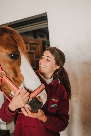Girl with adorable pony in hat