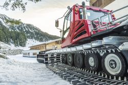 Side view of a snow groomer car