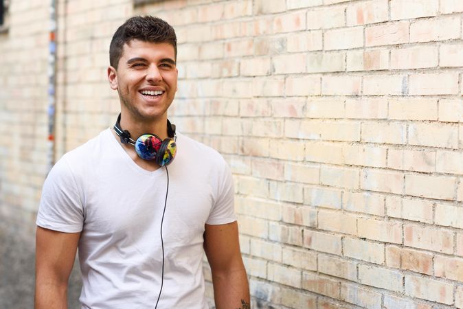 Happy young man with colorful headphones