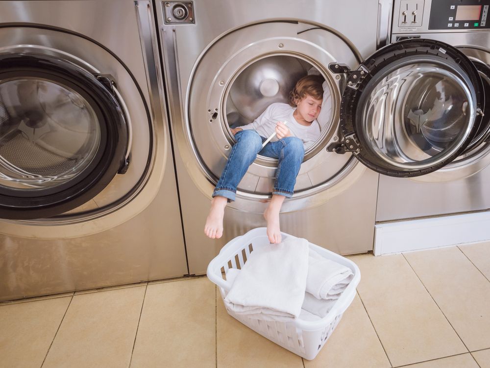 Boy sleeping in washing machine