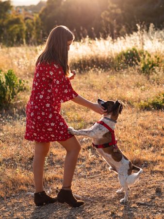 Woman with small friendly dog outdoors