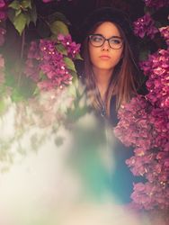 Woman on background of stunning violet flowers