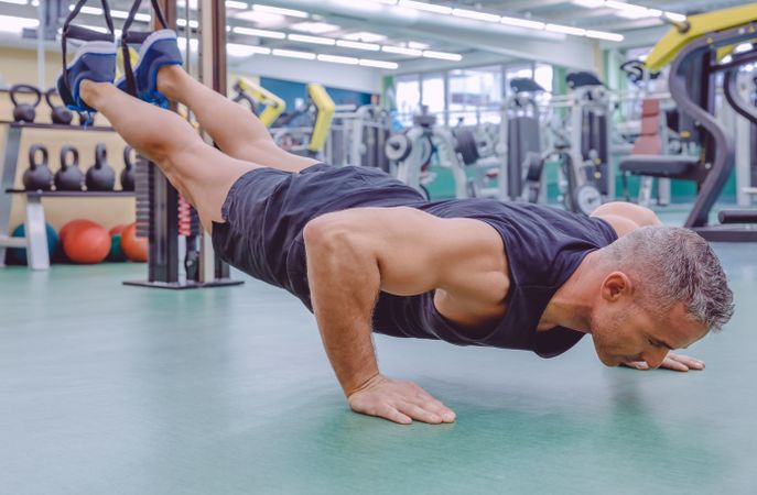 Man doing push ups with elevated legs