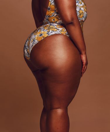 Side view of curvy Black woman’s leg and buttocks
