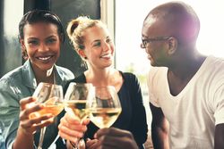 Three good friends toasting with wine glasses
