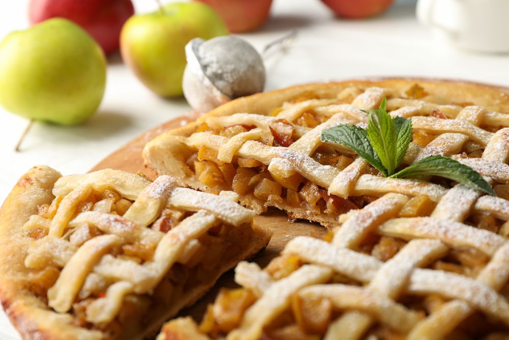Tasty apple pie on wooden background, close up. Homemade food