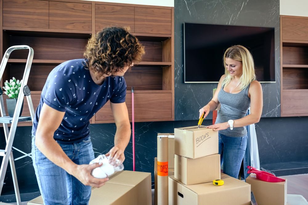 Couple unpacking moving boxes