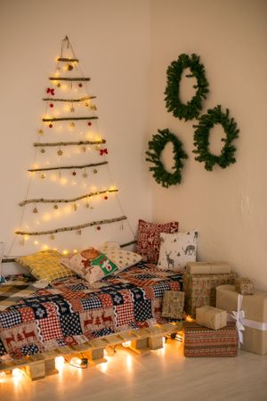 Floor bed decorated with Christmas lights and garlands