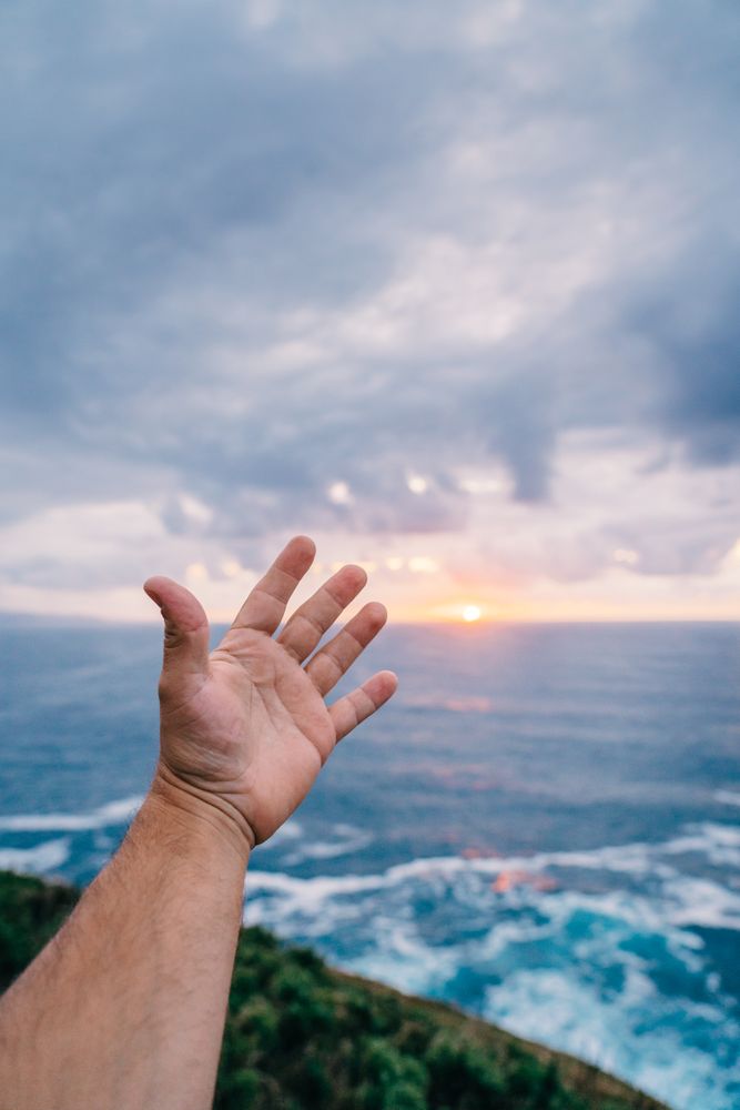 Person reaching for sea by hand