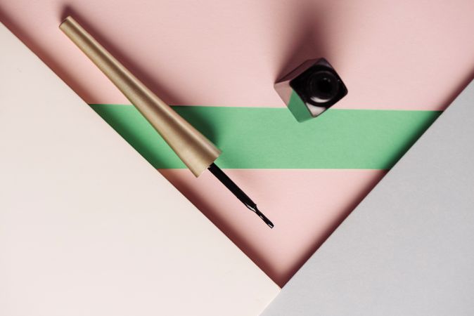 Liquid eyeliner brush on geometric background