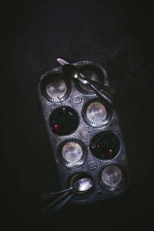 Blackberry and cherry in cake shape with spoon and knife