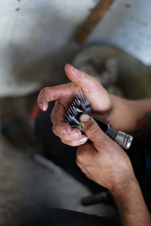 Crop farmer adjusting shearing machine