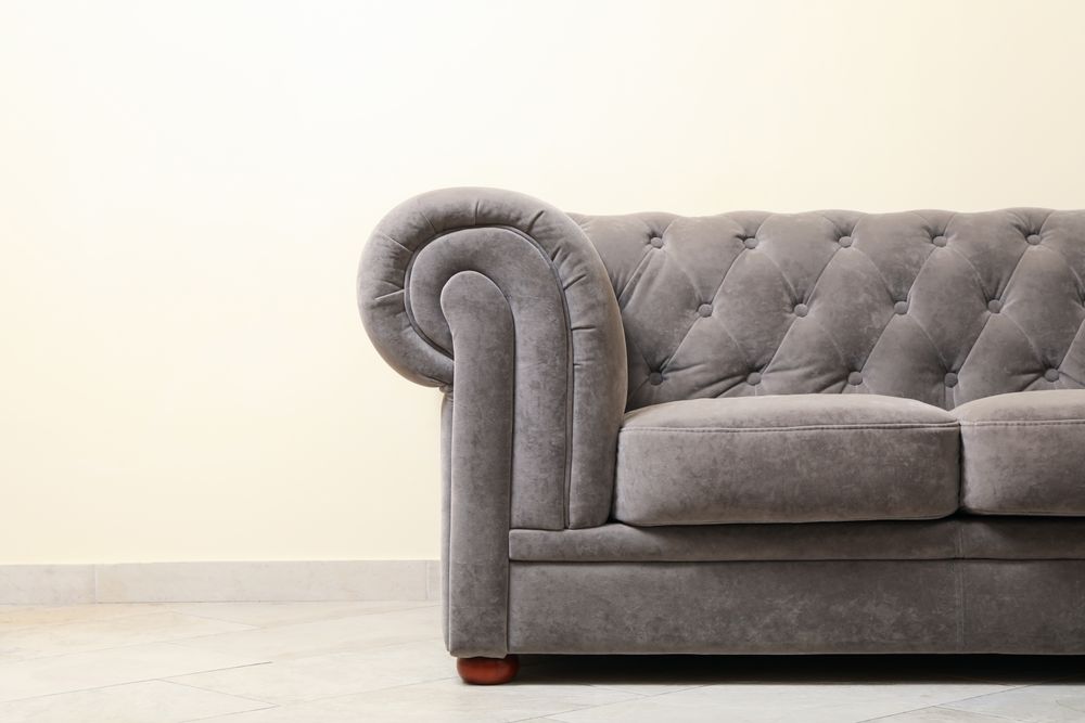Simple interior with sofa against light beige wall