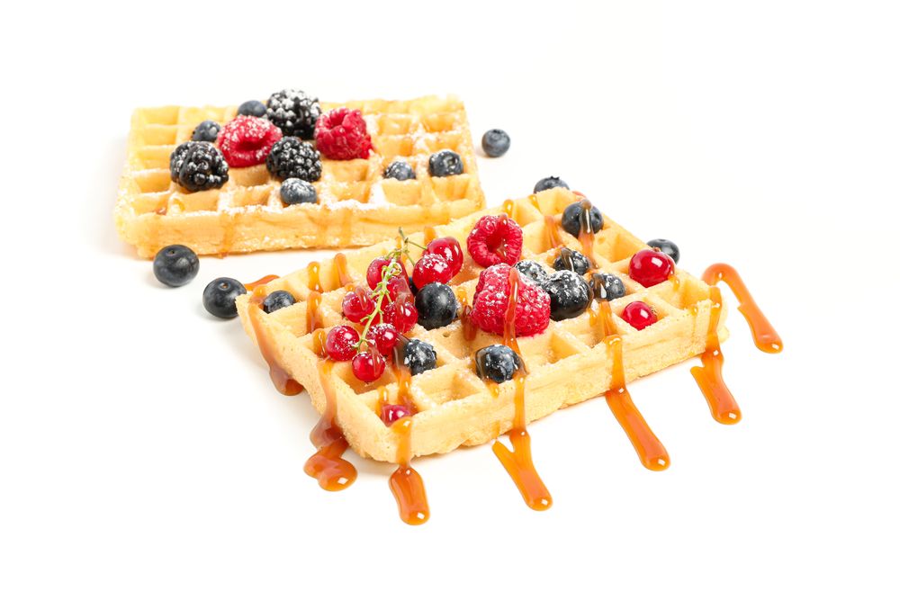 Waffles under caramel topping isolated on blank background