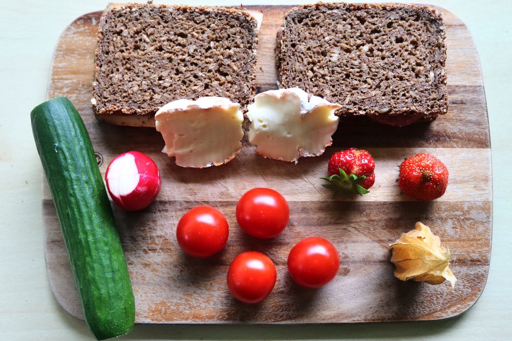 Close view on a healthy german breakfast with sandwiches, tomatoes and cucumbers