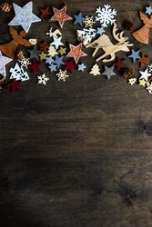 Top view of flat cut out Christmas ornaments along top of table