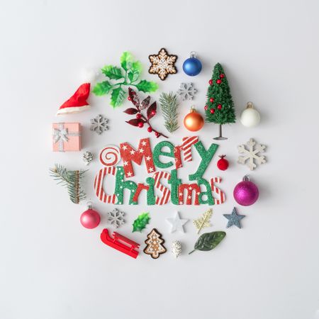 Flat lay of Christmas cookies and decorations in circle, with “Merry Christmas”
