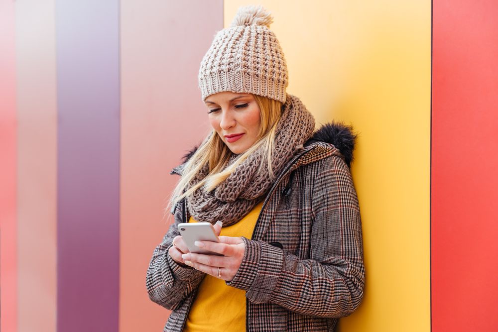 Portrait of blonde woman writing on her phone