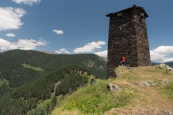Man near tall old defensive building