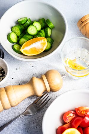 Ingredients of cucumber, lemon and salt & pepper on concrete background