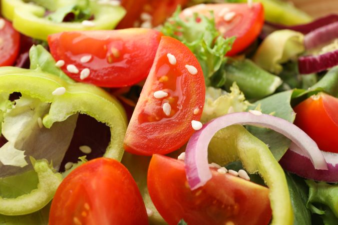 Fresh salad with sesame on whole background, close up