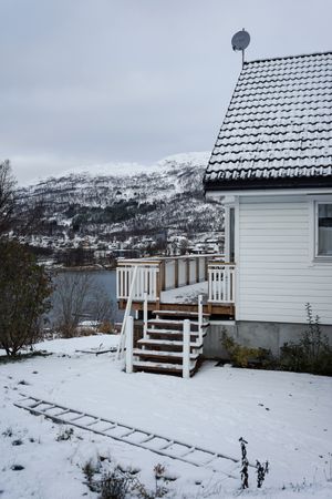 Small country house on lake in winter