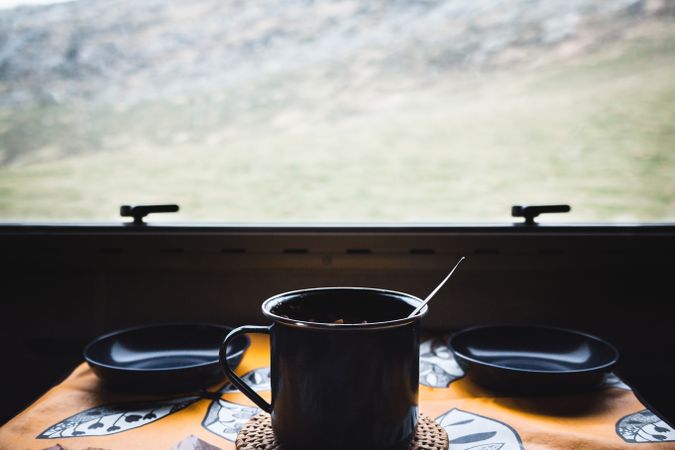 Mug and empty bowls near window