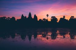 Bright sunset sky over temple and lake