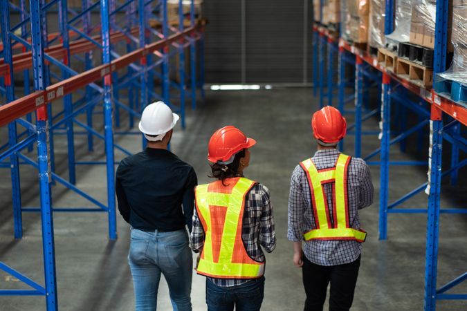 Team of warehouse workers inspecting inventory in a logistics facility.