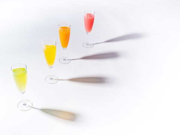 Glasses of bright colorful drinks on table