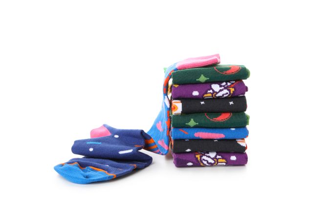 Funny patterned socks isolated on light background